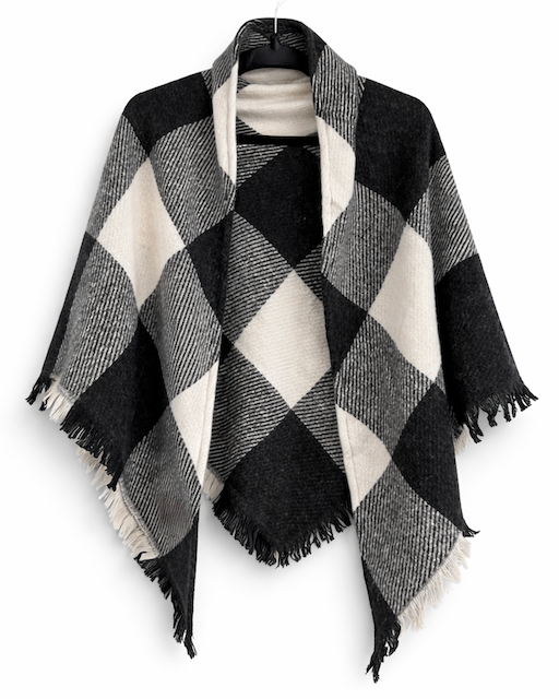 A black and off-white plaid fringed poncho wrap displayed on a hanger against a plain white background.