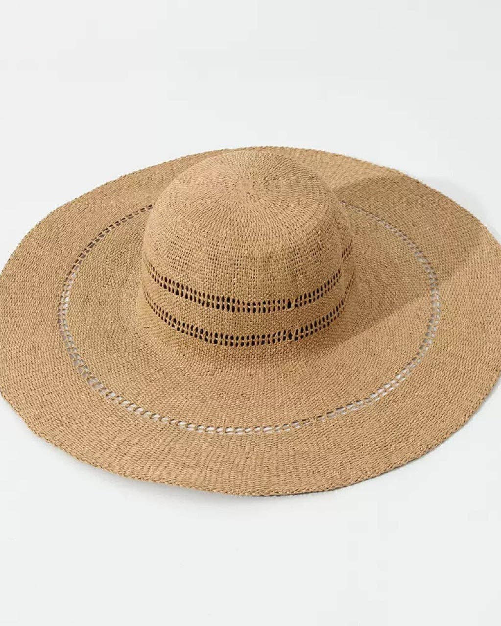 Beige straw hat with wide brim on a light gray background