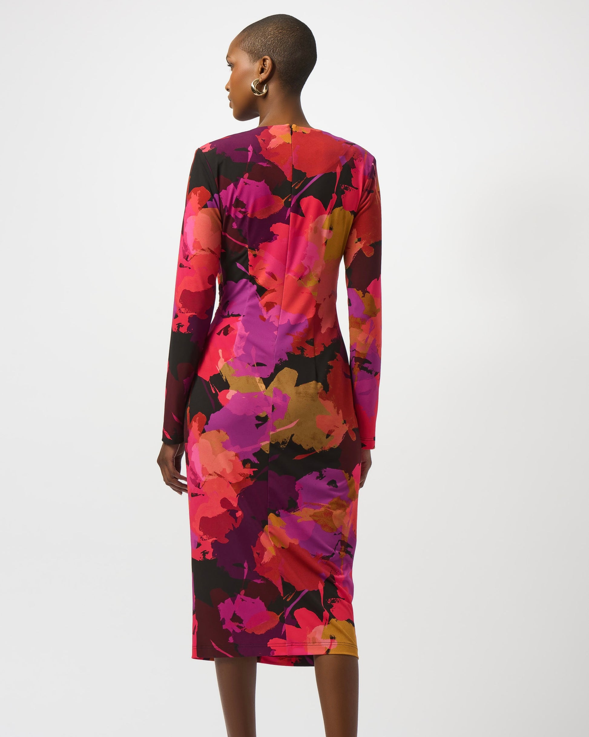 Model is wearing Jospeh Ribkoff Silky Knit Floral Print Sheath Dress in color Black Multi on a white background. 