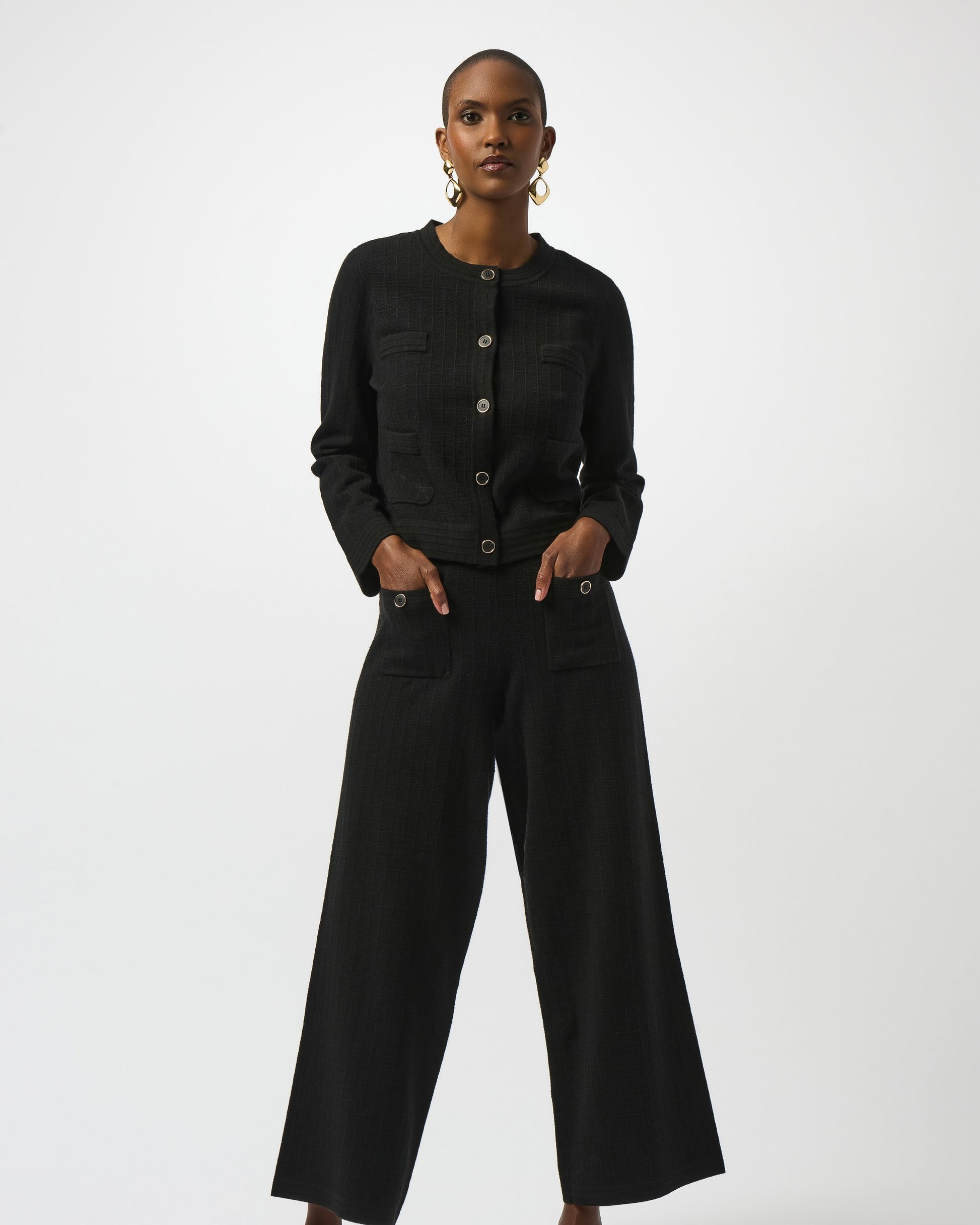 Model is wearing Joseph Ribkoff Sweater Knit Button Front Jacket in black with black knit pants on a white background
