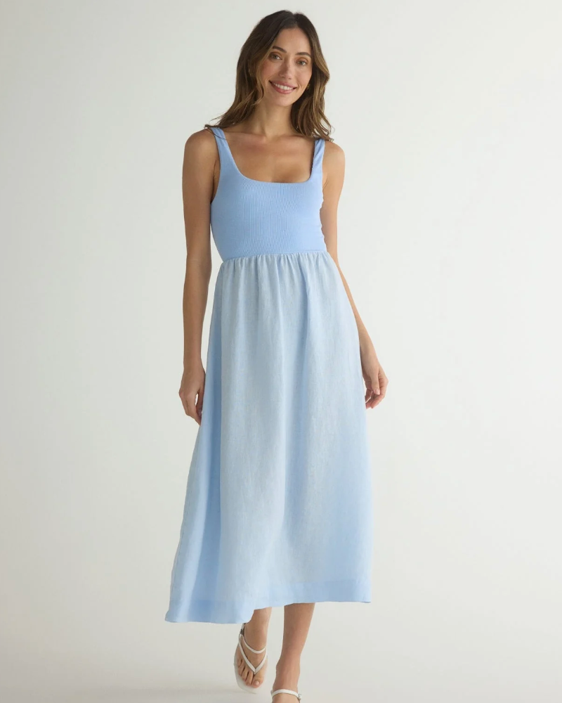 Model is wearing Bella Dahl Sleeveless Knit Combo Dress in Periwinkle blue with white sandals on a white background