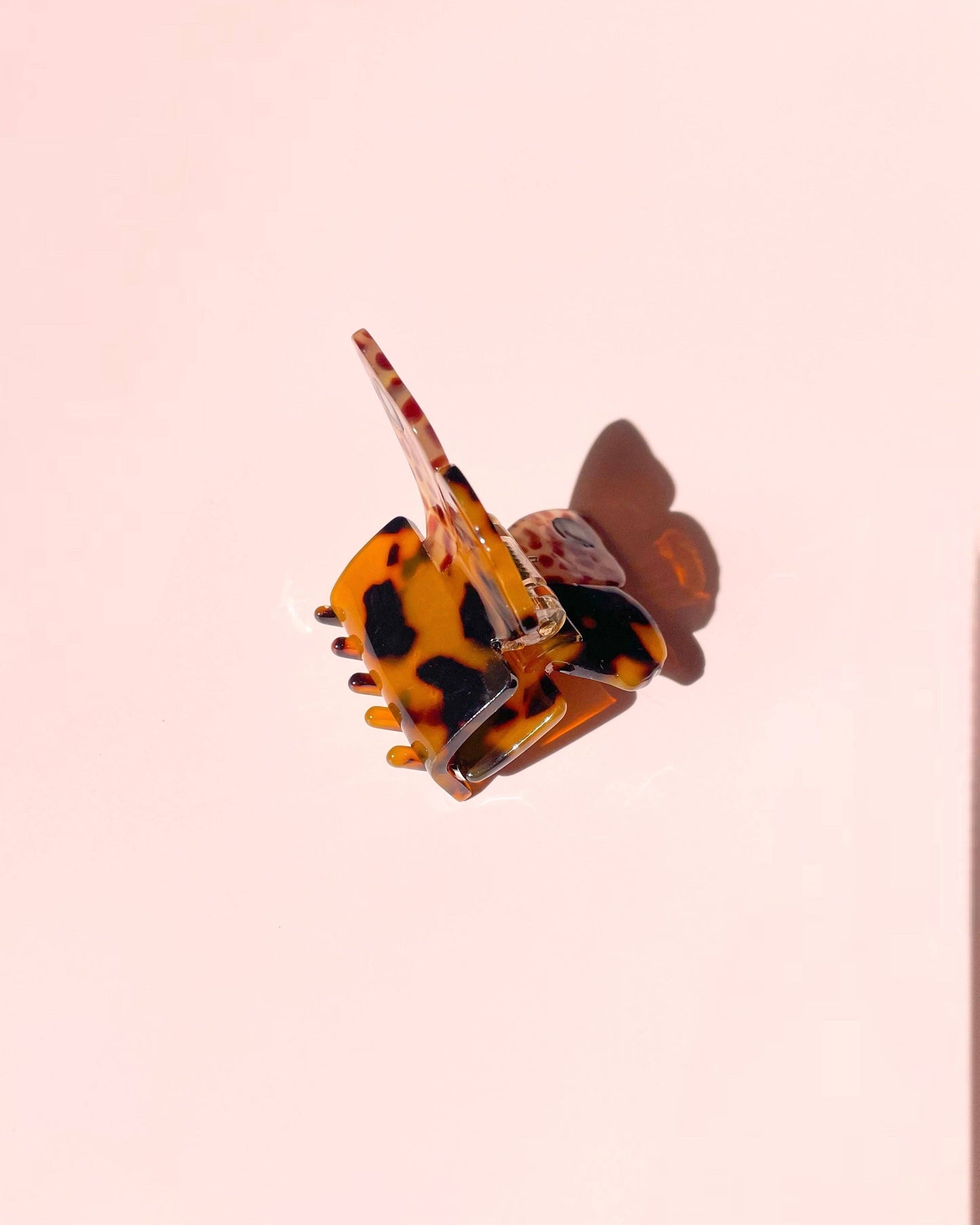 Tortoiseshell hair clip on a pink background