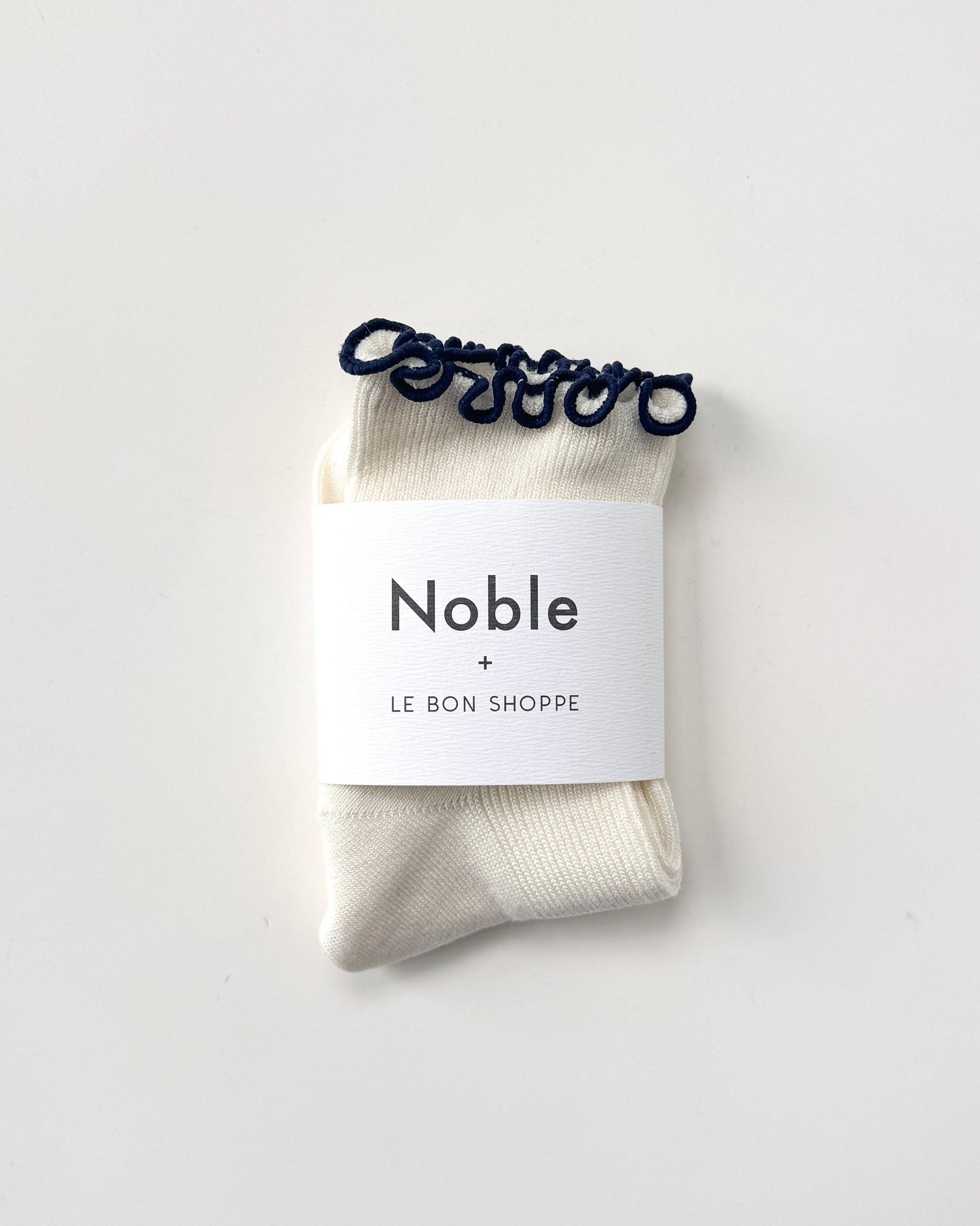 Pack of socks with 'Noble' label on a white background