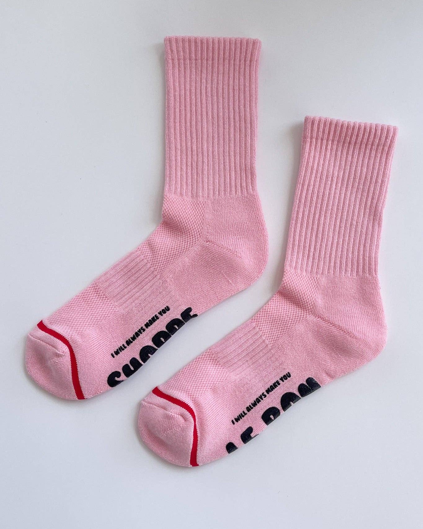 Pair of pink socks with text on a white background