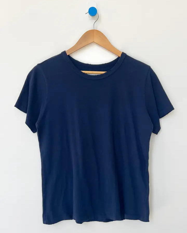 Navy blue t-shirt on a wooden hanger against a white background