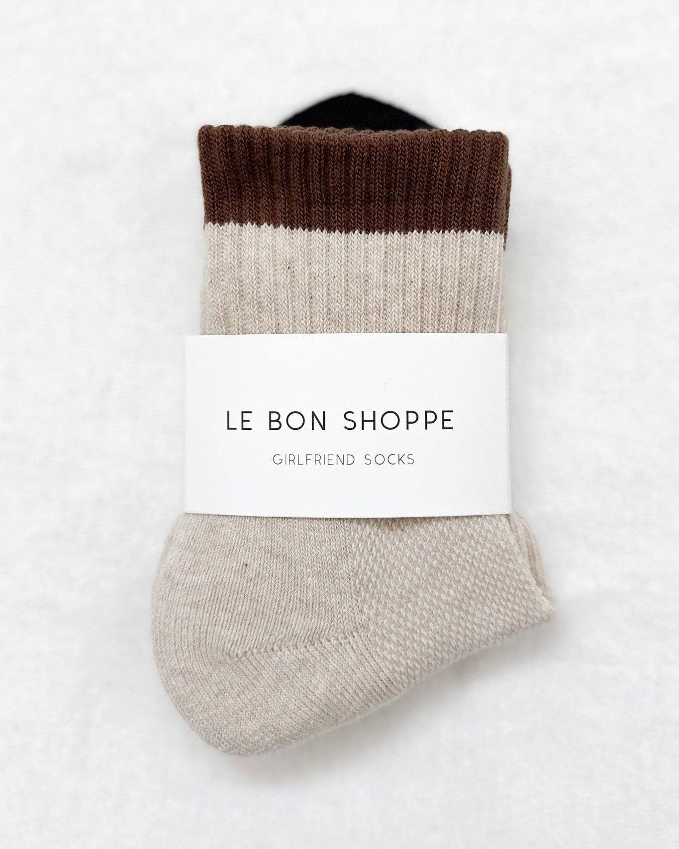 Pair of color-blocked socks with a label on a white background