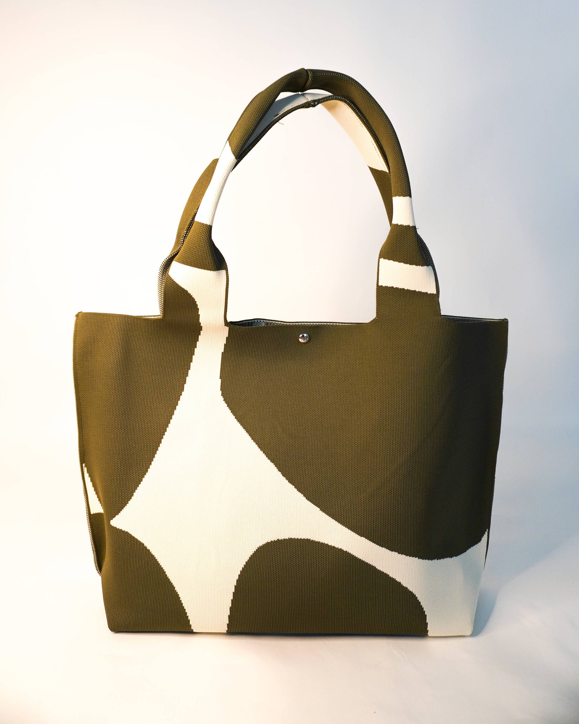Brown and white patterned tote bag on a light gray background
