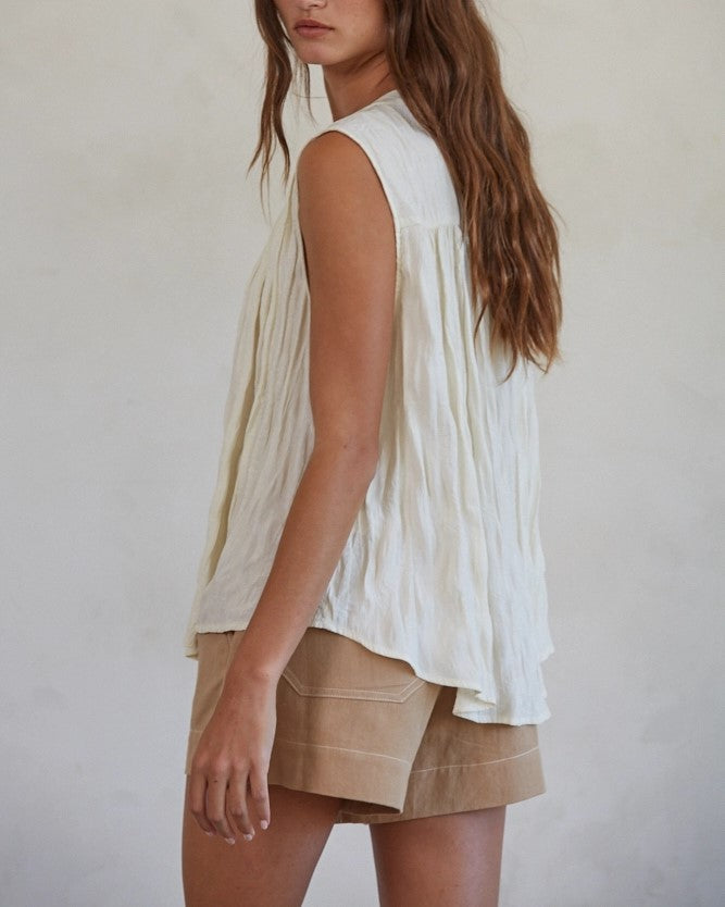 Model wearing By Together Brown Cotton linen wide leg shorts wearing white tank on a white background