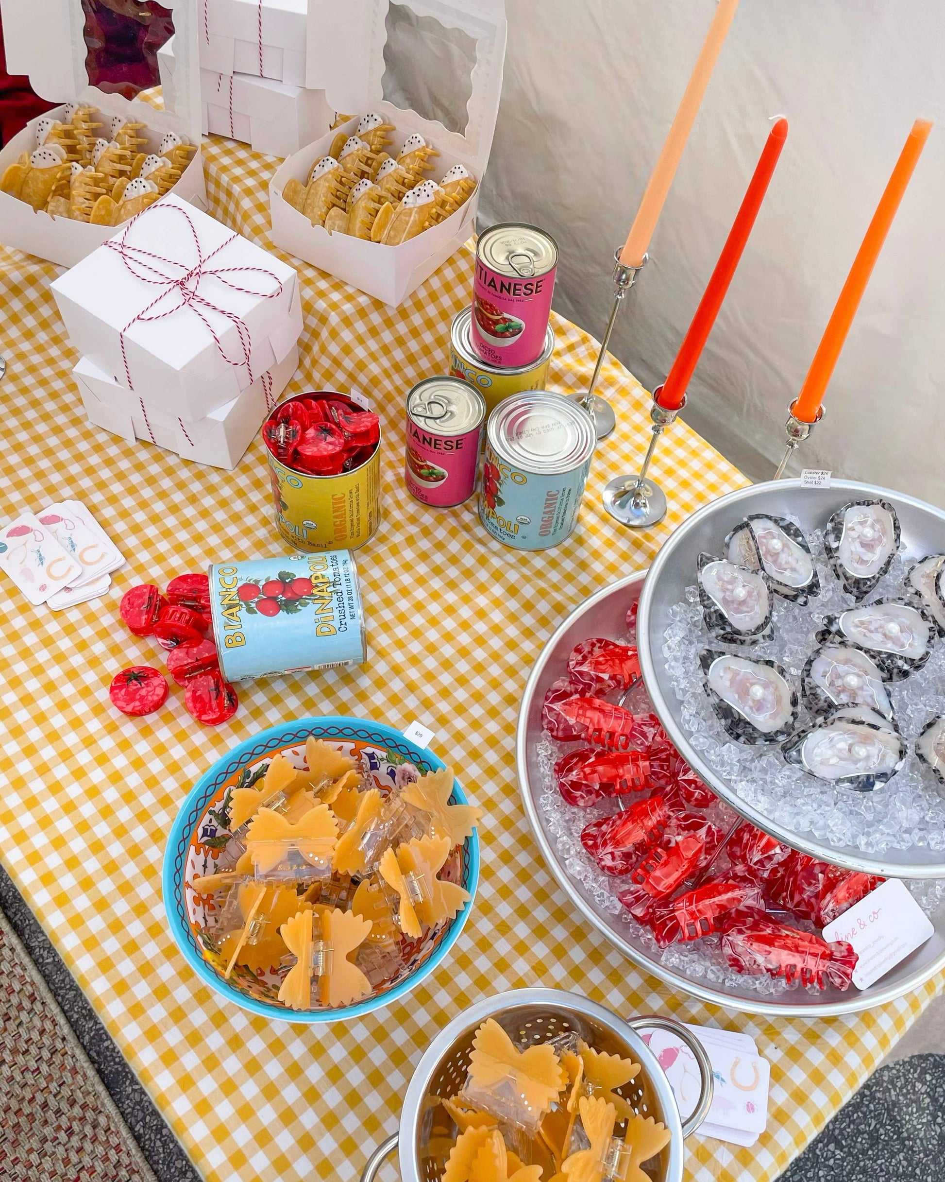Table with various food items and drinks on a yellow checkered tablecloth