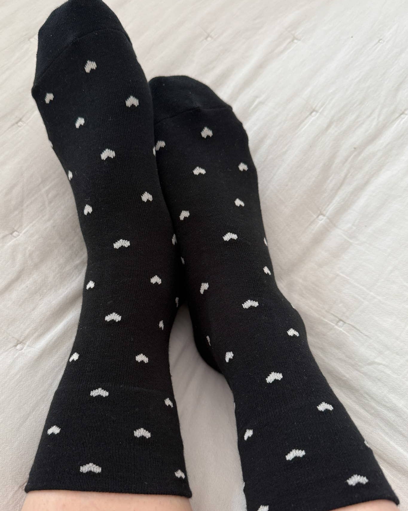 Black socks with white patterns on a light gray background