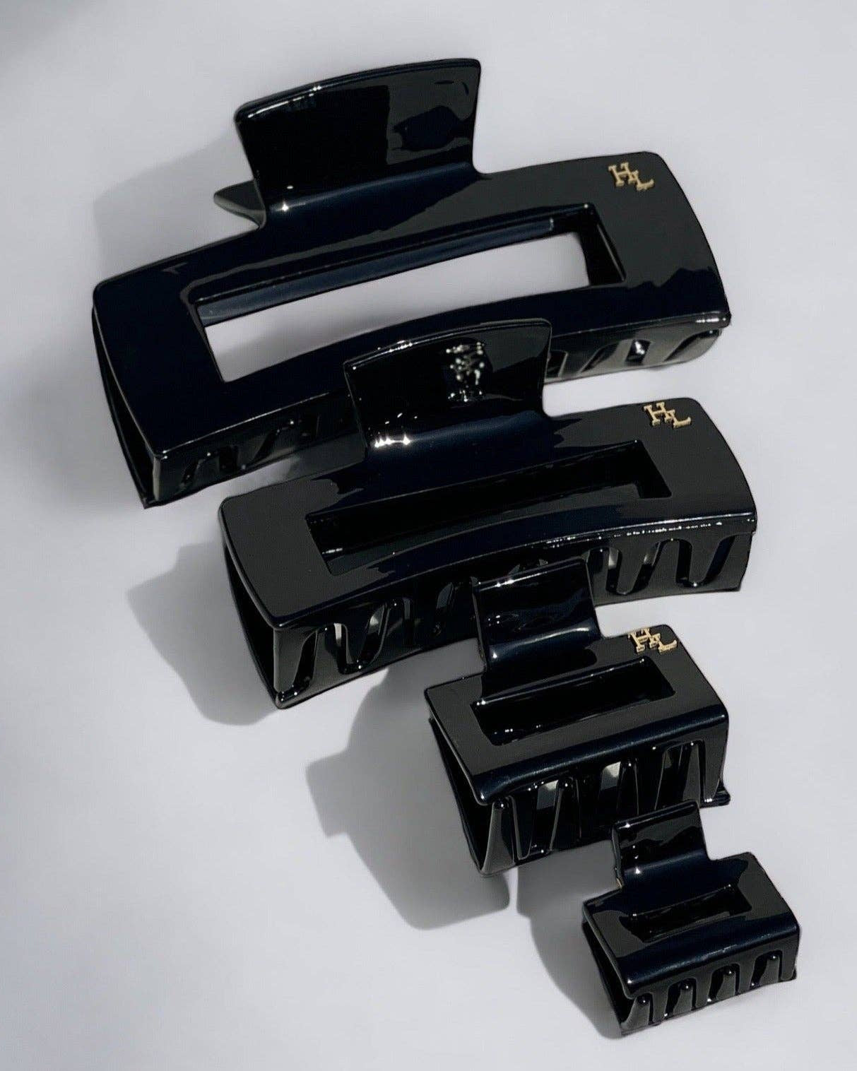 Three black hair clips on a white background