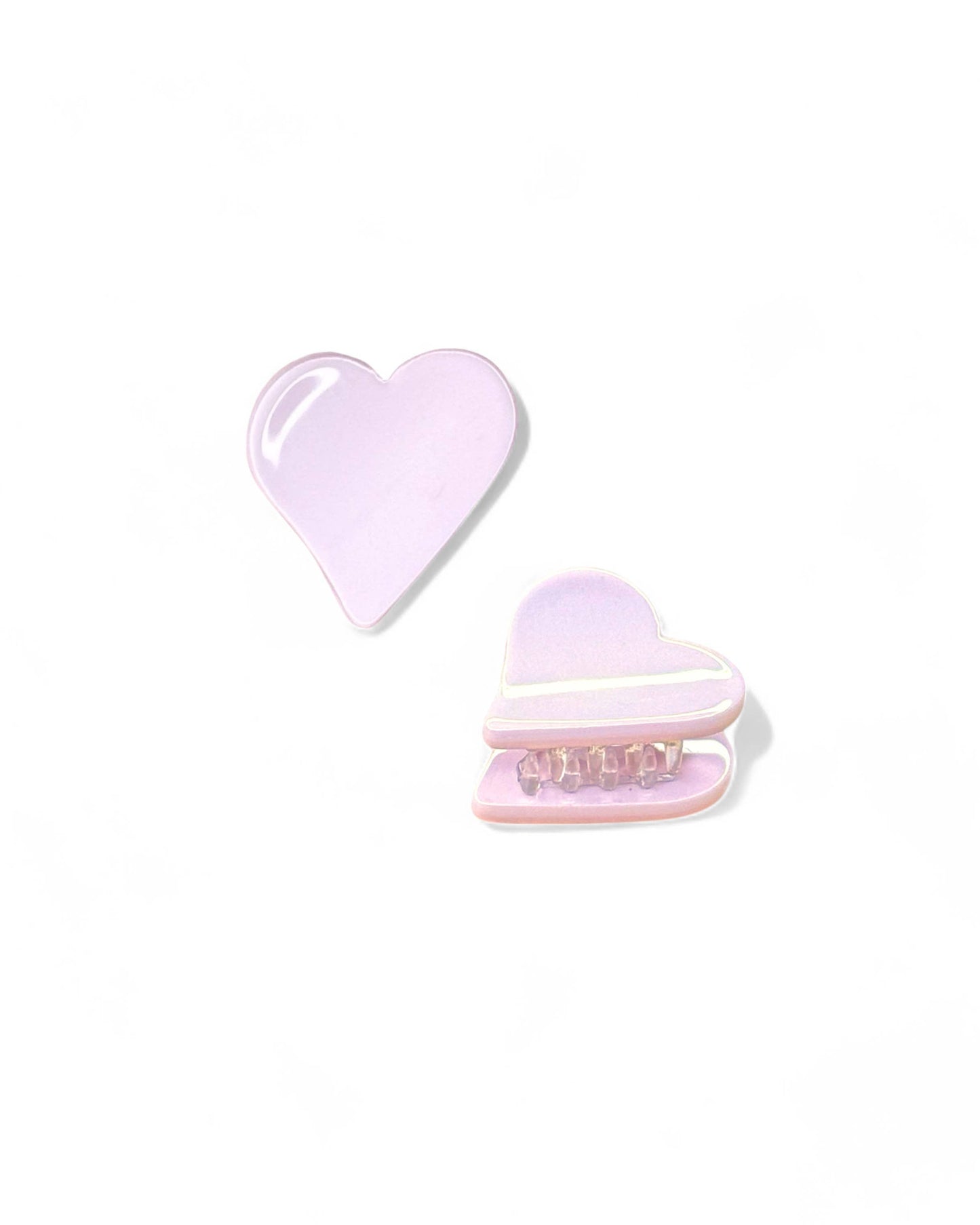 Two heart-shaped objects, one plain and one with a macaron design, on a white background.