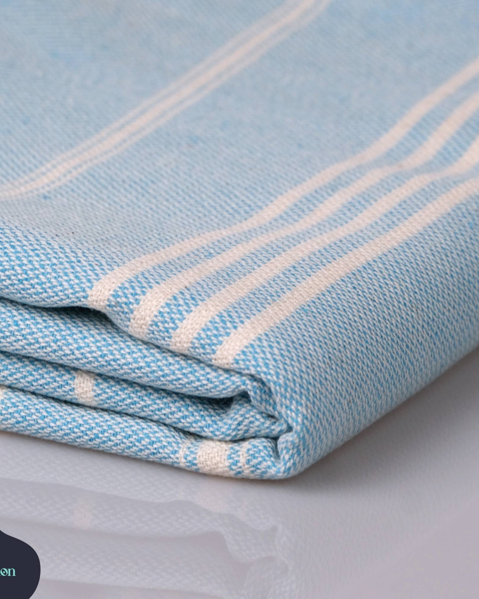 Folded blue and white striped fabric on a light gray background with Kalliston logo.