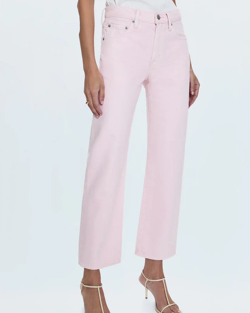 pink jeans on a model standing in front of a whitle background