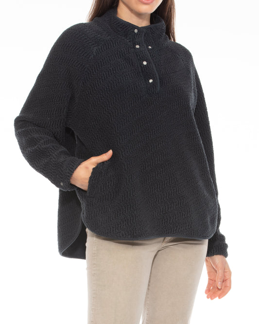 Person wearing a black sweater with a white background