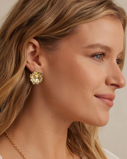 Model wearing Gorjana Camilla Stud gold earrings on a white background