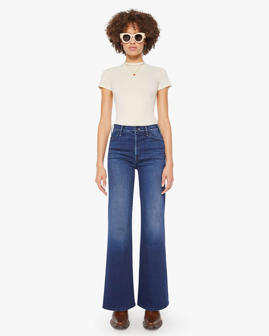 Person wearing a white t-shirt and blue jeans on a white background