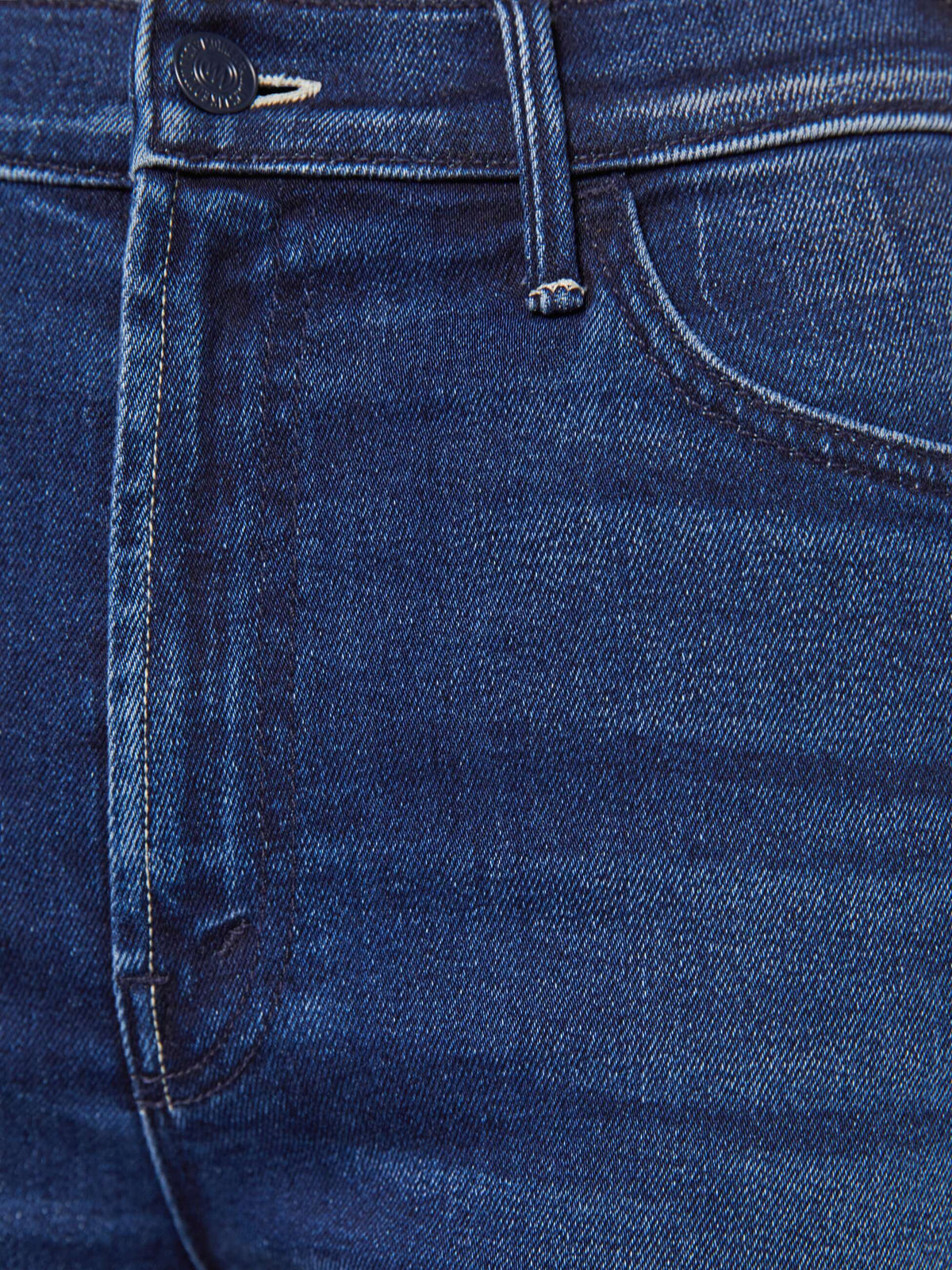 Close-up of blue denim fabric with stitching details