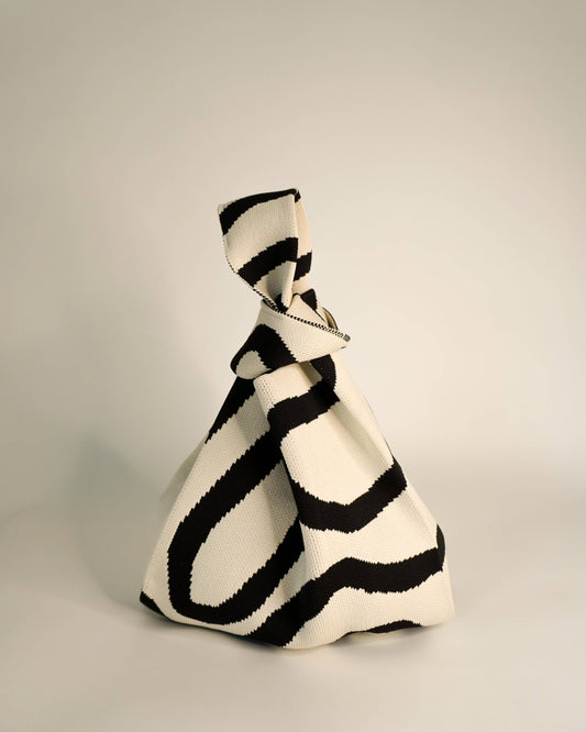 Black and white striped bag on a light gray background