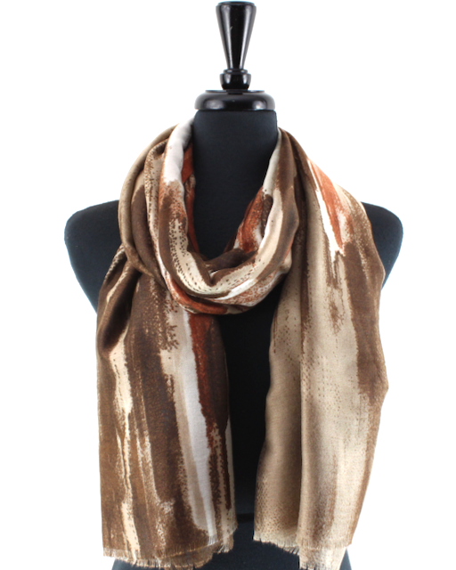 A lightweight scarf with an abstract brushstroke pattern in shades of brown, beige, and white, draped on a black mannequin torso against a plain white background.