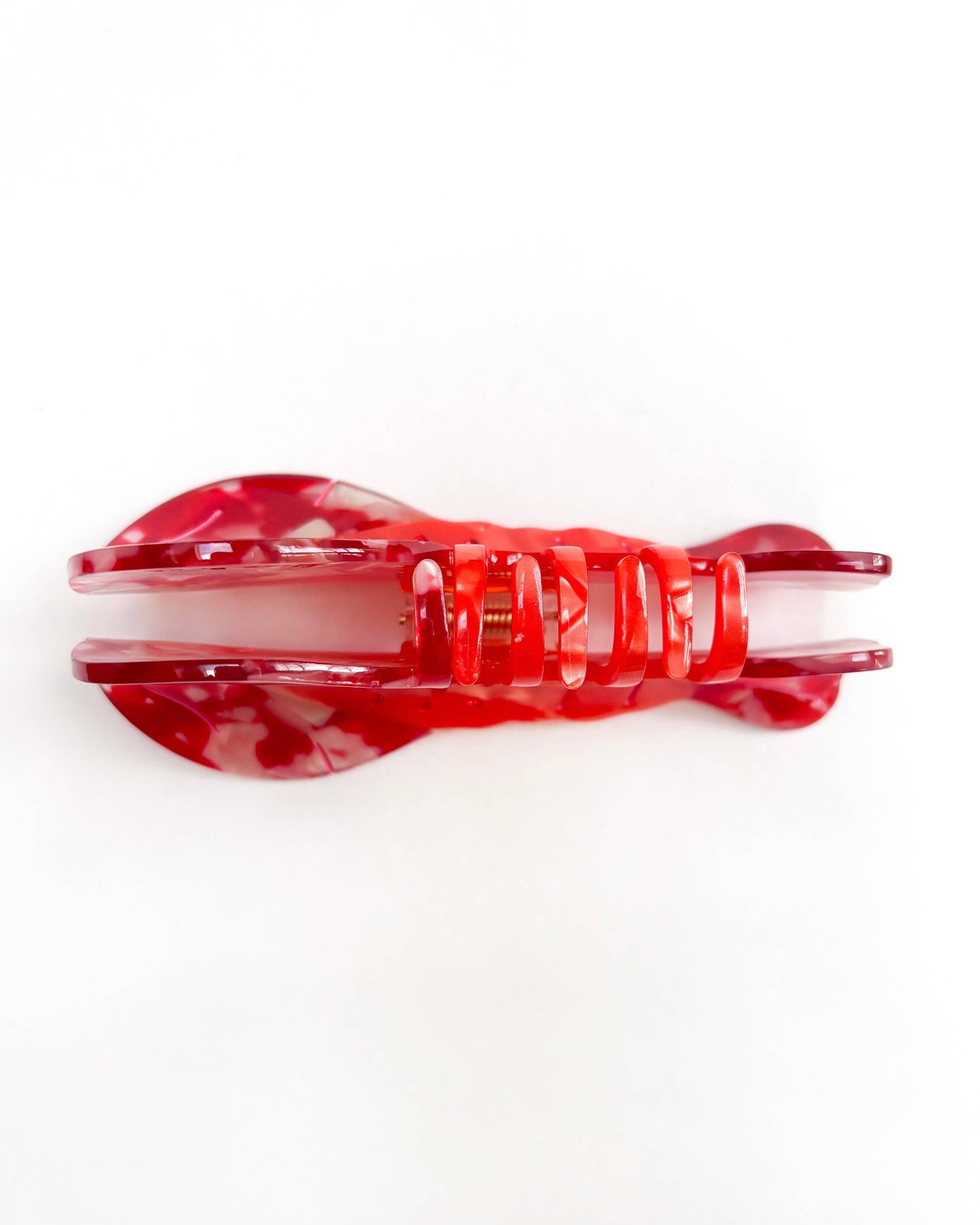 Front view of a red lobster hair clip on a white background