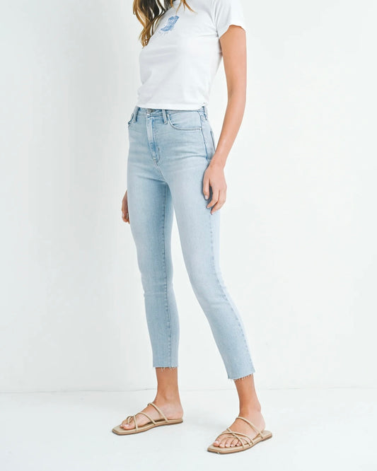 Model wearing Just Black Denim HR Curvy Stretchy Skinny jeans wearing white tee and sandals on a white background