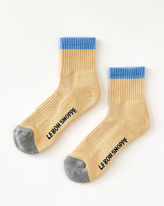 Beige socks with blue tops and gray toes on a white background, featuring 'Le Bon Shoppe' branding.