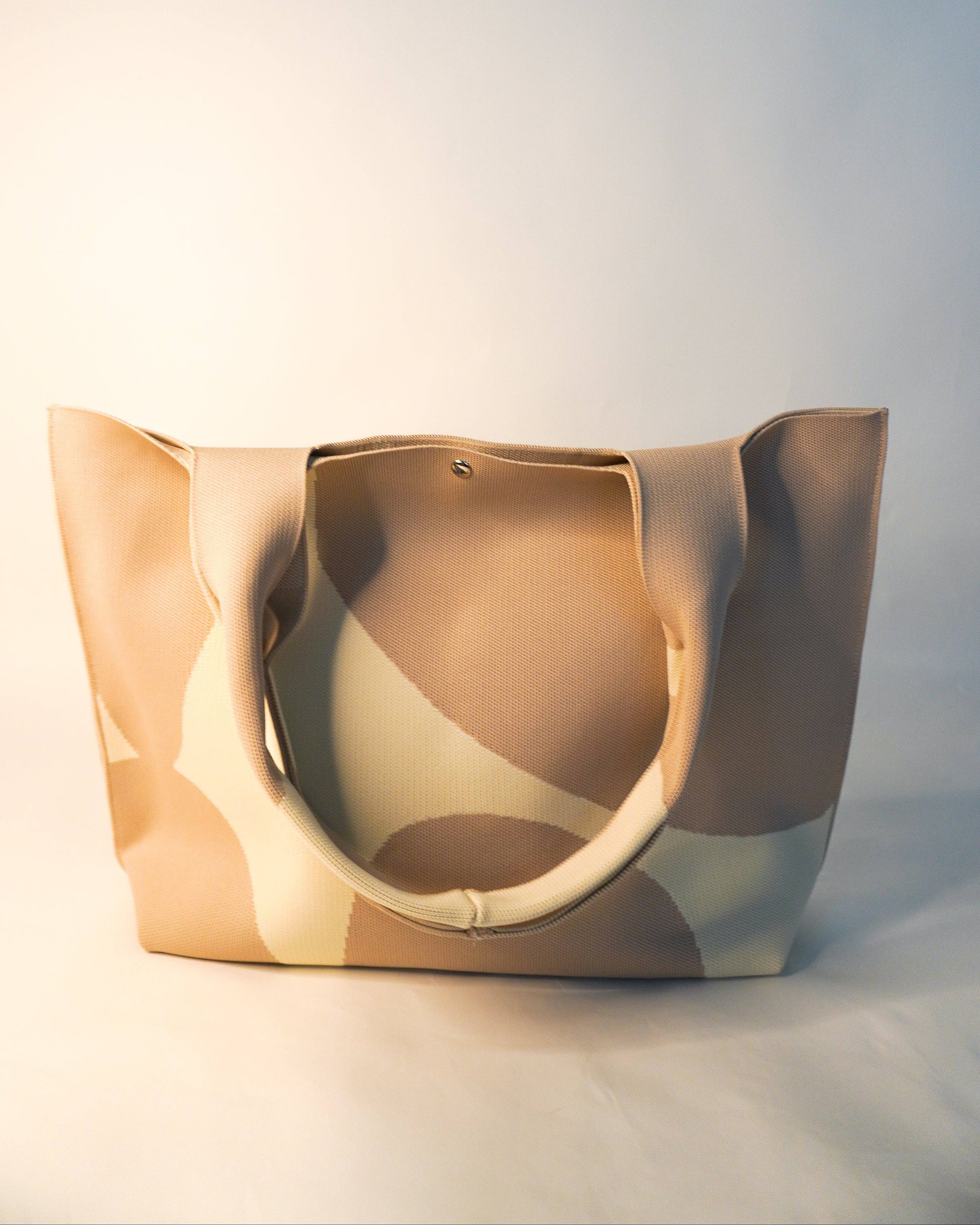 Beige tote bag on a light gray background