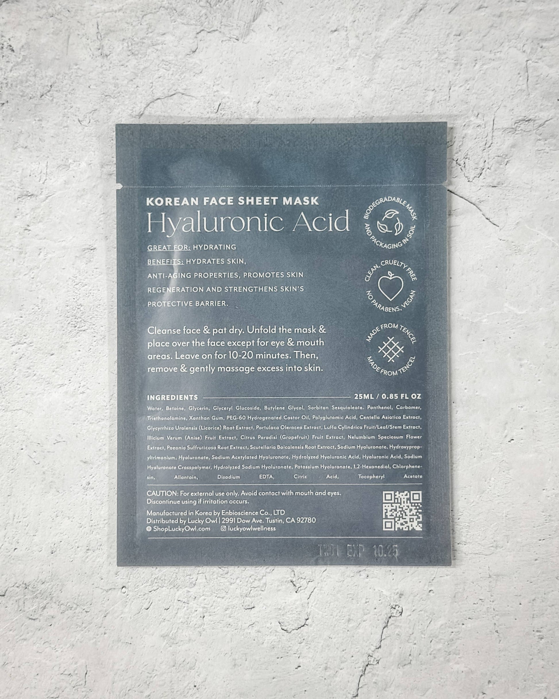 Korean face sheet mask packaging with text on a gray textured background