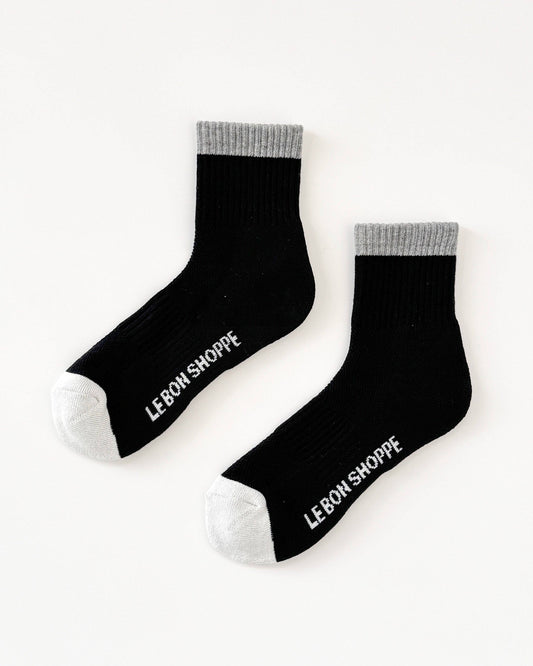 Black socks with 'Le Bon Shoppe' branding on a white background