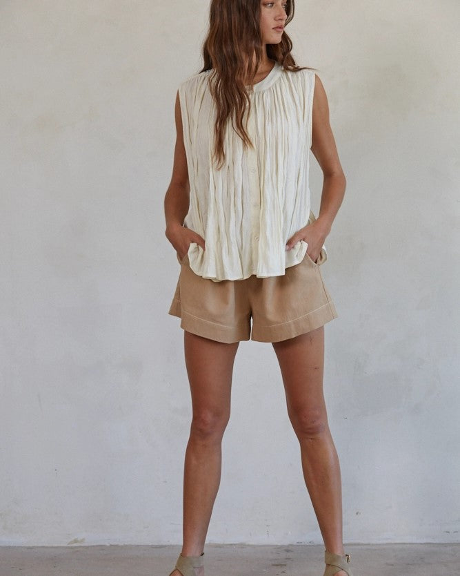 Model wearing By Together Brown Cotton linen wide leg shorts wearing white tank on a white background