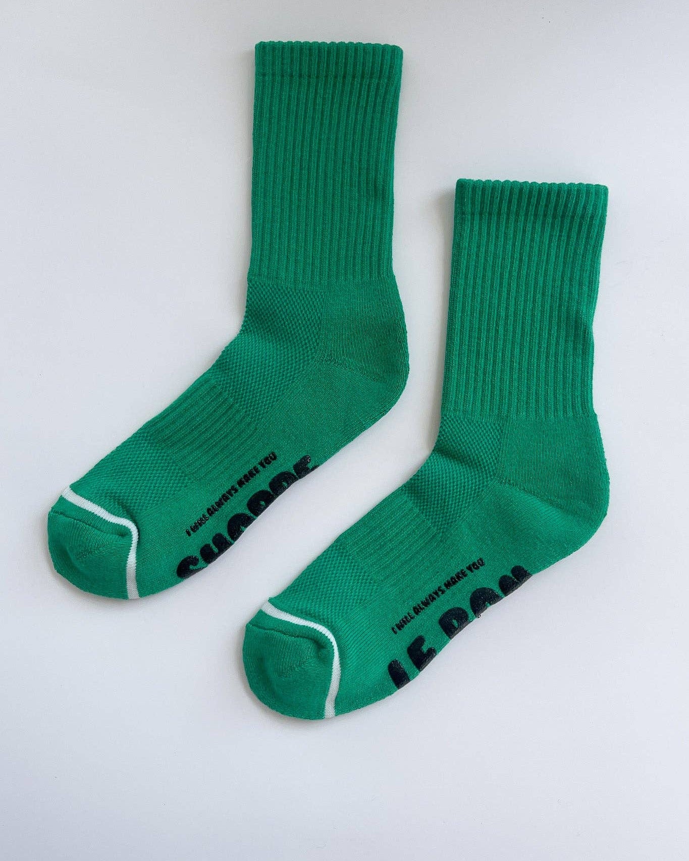 Pair of green socks with text on a white background