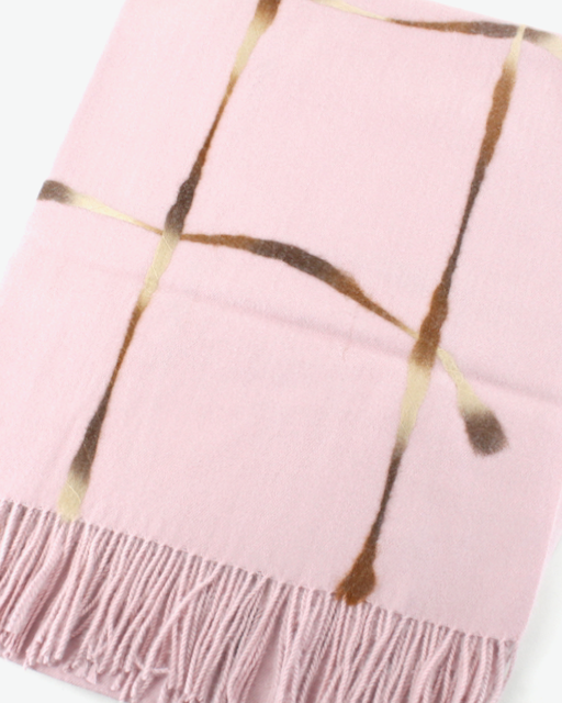A light pink throw blanket with a metallic gold abstract grid pattern and fringed edges, shown on a clean white background.