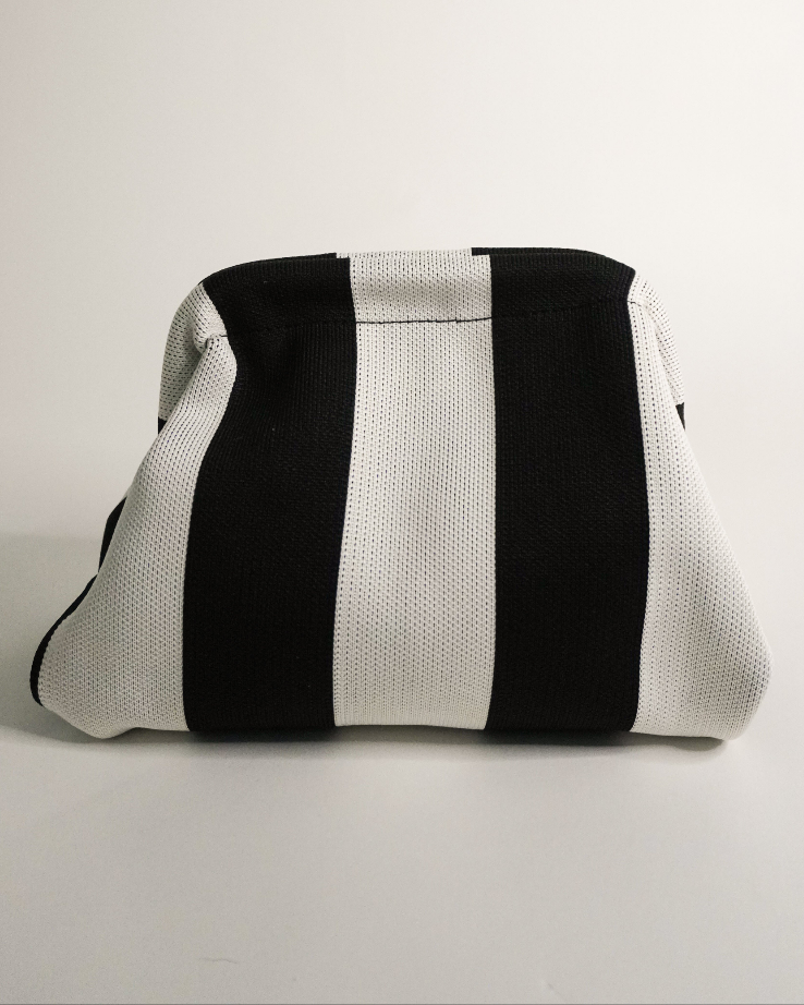 Black and white clutch back on a white background