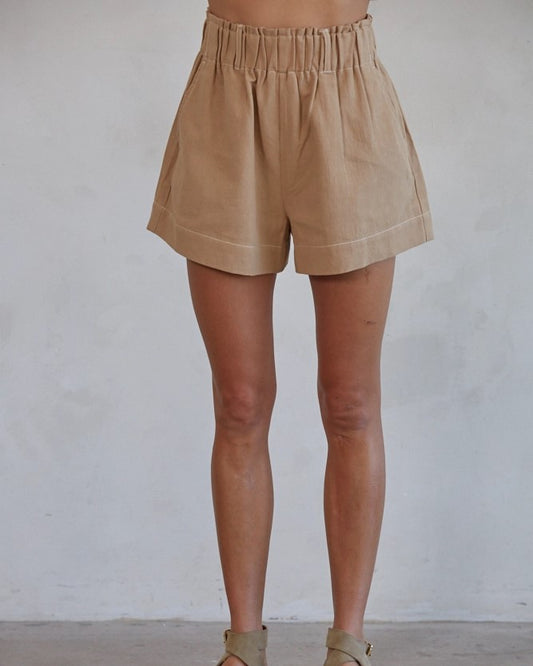 Model wearing By Together light brown Cotton Linen Wide Leg Shorts on a white background