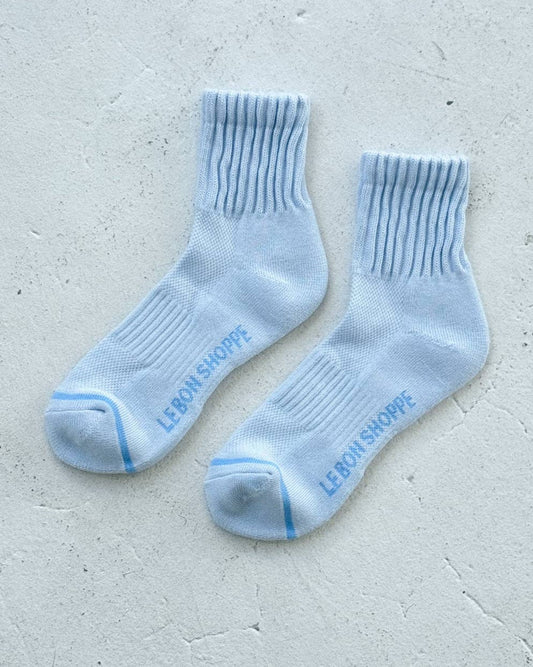 Pair of light blue socks with 'Levi's' branding on a light gray background