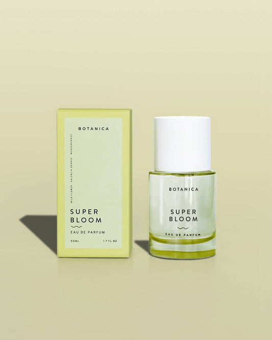 Botanica Super Bloom eau de parfum bottle and packaging on a beige background