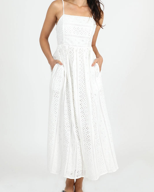 Close up view of the Greylin Portia cotton eyelet dress in white standing in front of a white back drop