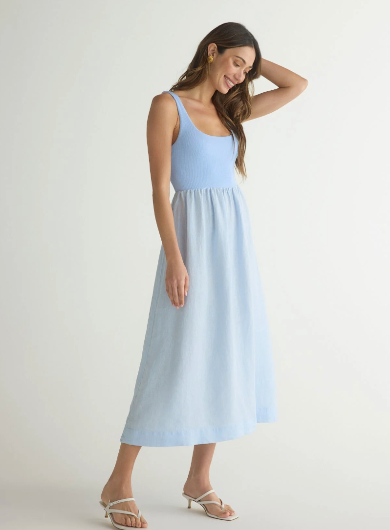 Model is wearing Bella Dahl Sleeveless Knit Combo Dress in Periwinkle blue with white sandals on a white background