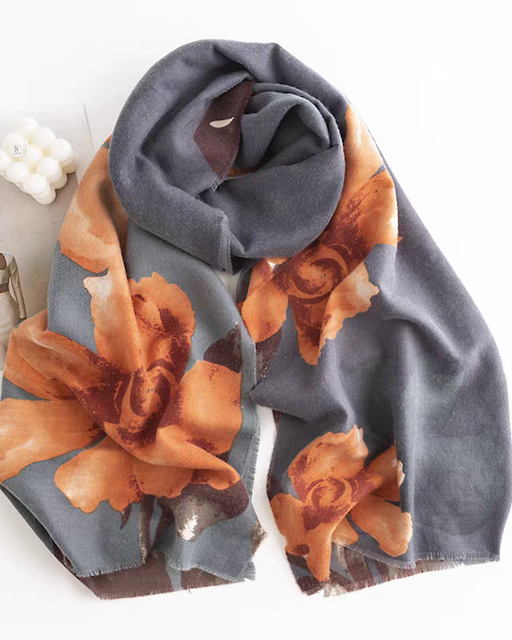 Floral patterned scarf with gray background on a white surface