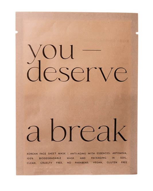 Korean face sheet mask packaging with text 'you deserve a break' on a beige background