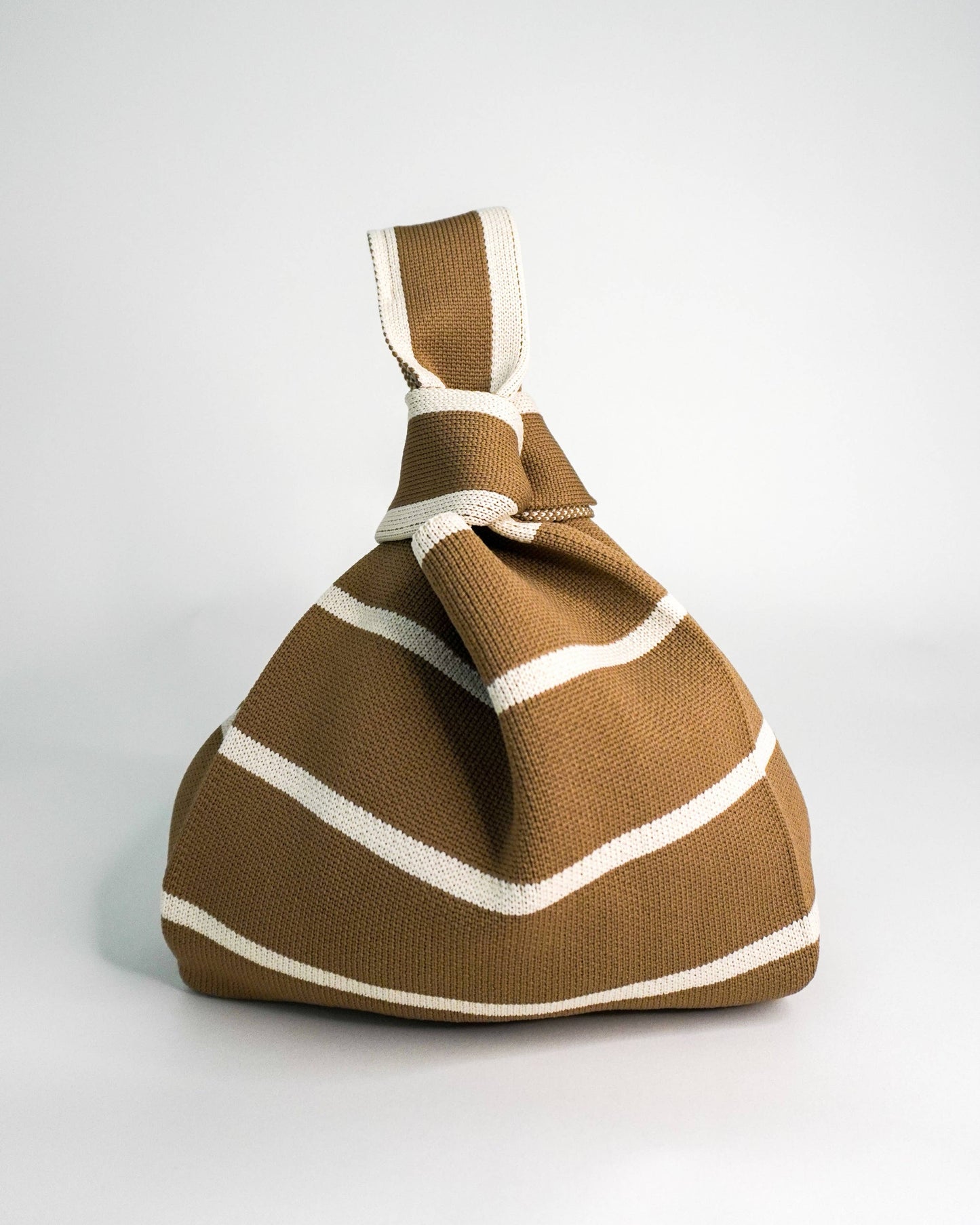 Brown bag with white stripes on a white background