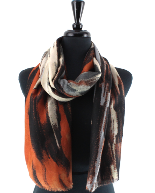 A patterned scarf draped on a black mannequin torso against a plain white background. The scarf features an abstract brushstroke design in orange, black, beige, and gray.
