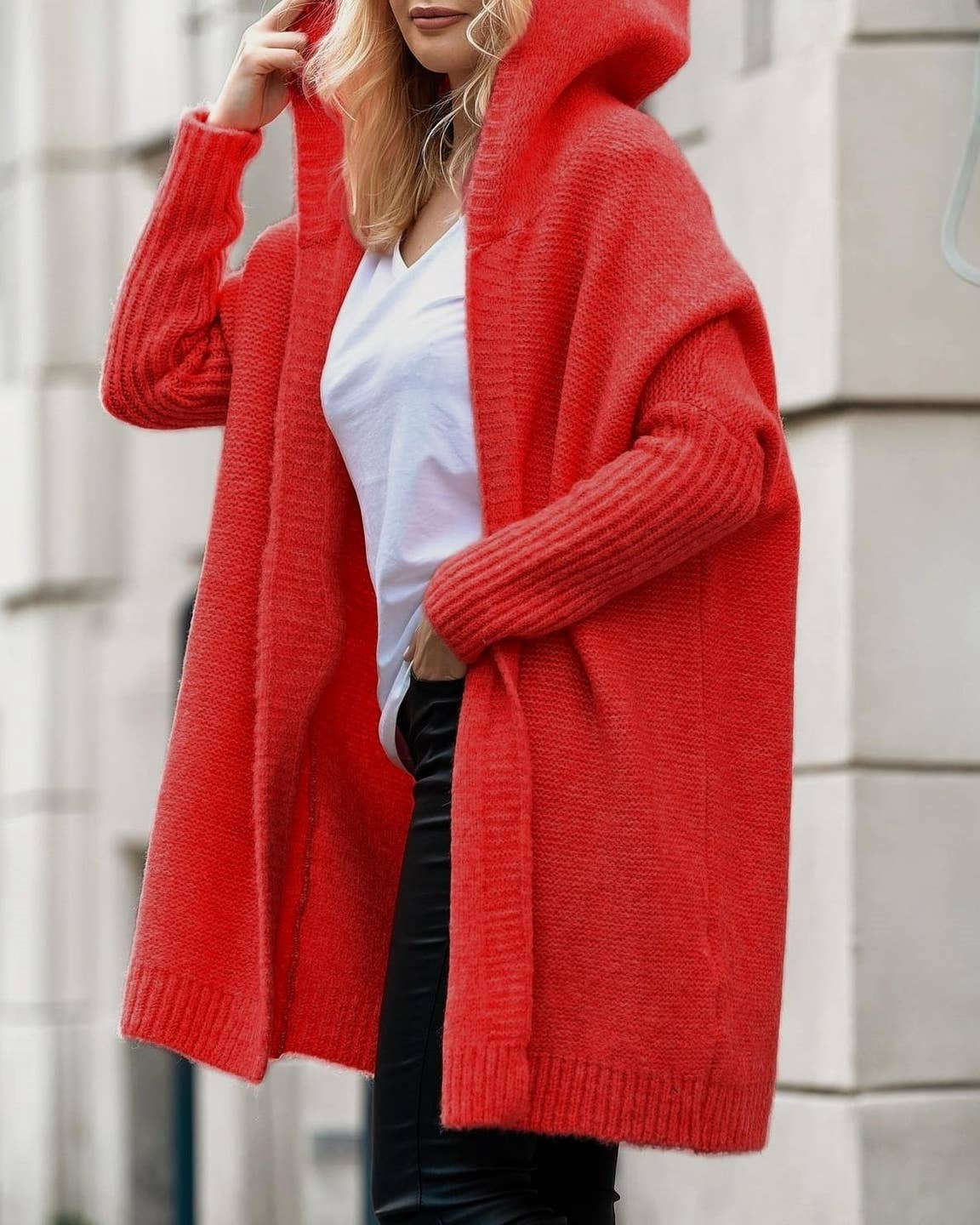 Model wearing Rosa Clothing  Knitted Hooded Cardigan Coat Wearing black pants and a white shirt standing outside 