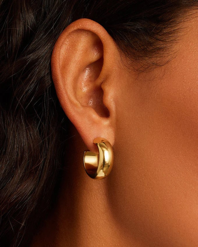 Image of an ear wearing Gorjana Paseo Small Gold Hoops 