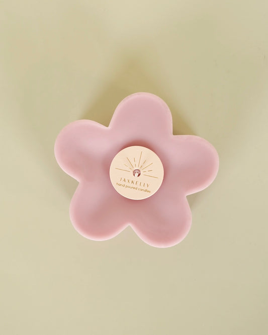 Image of JaxKelly Petal Candle pink on a yellow background