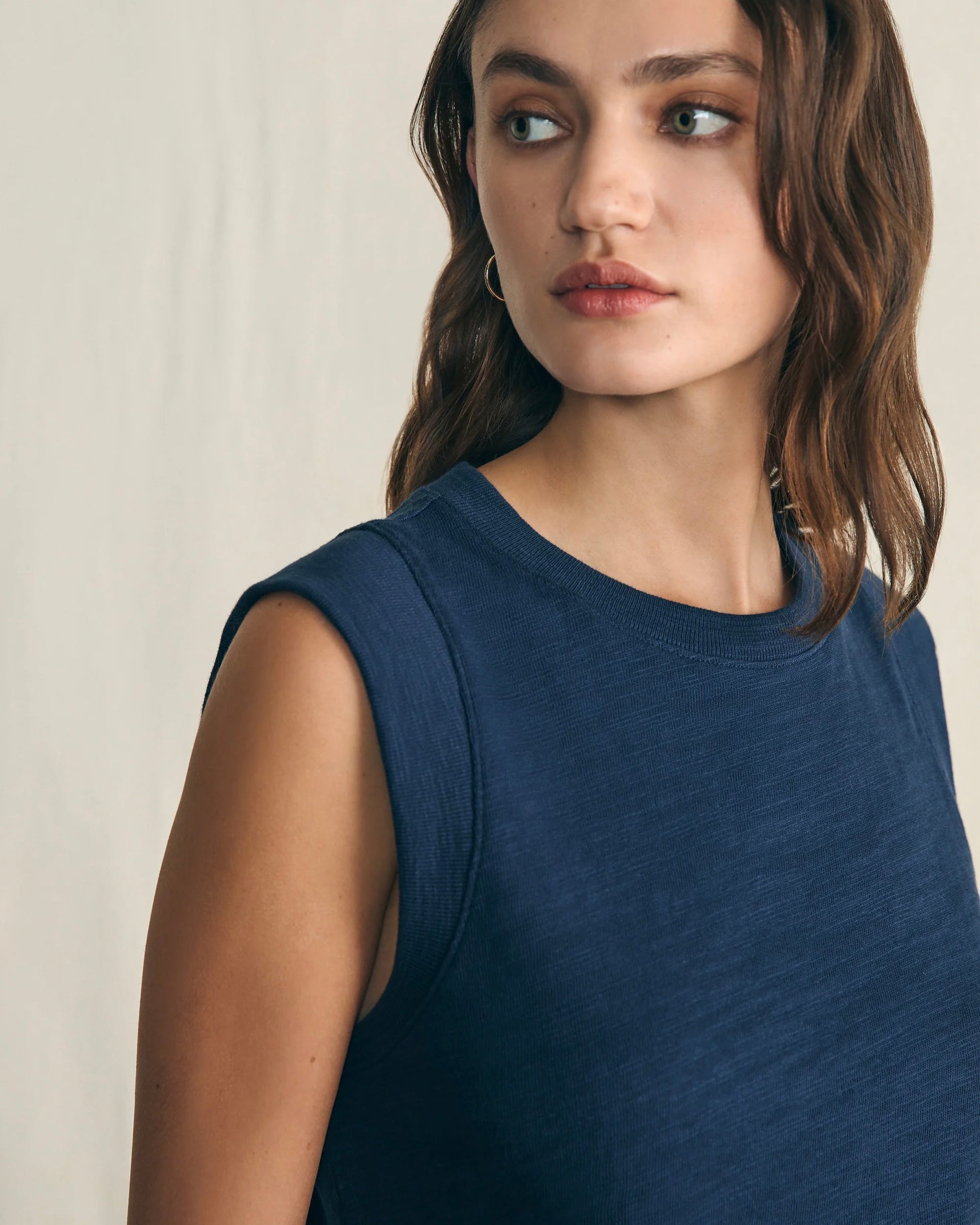 Model wearing Faherty Sunwashed slub Muscle Tank in Navy on a white background