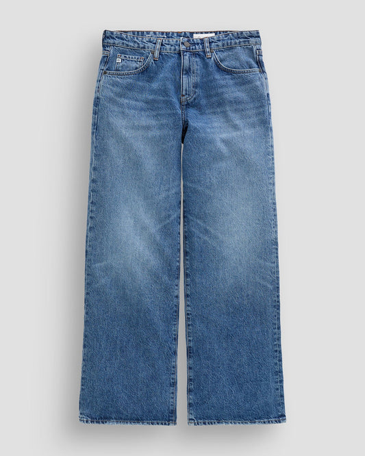 Pair of blue jeans on a light gray background