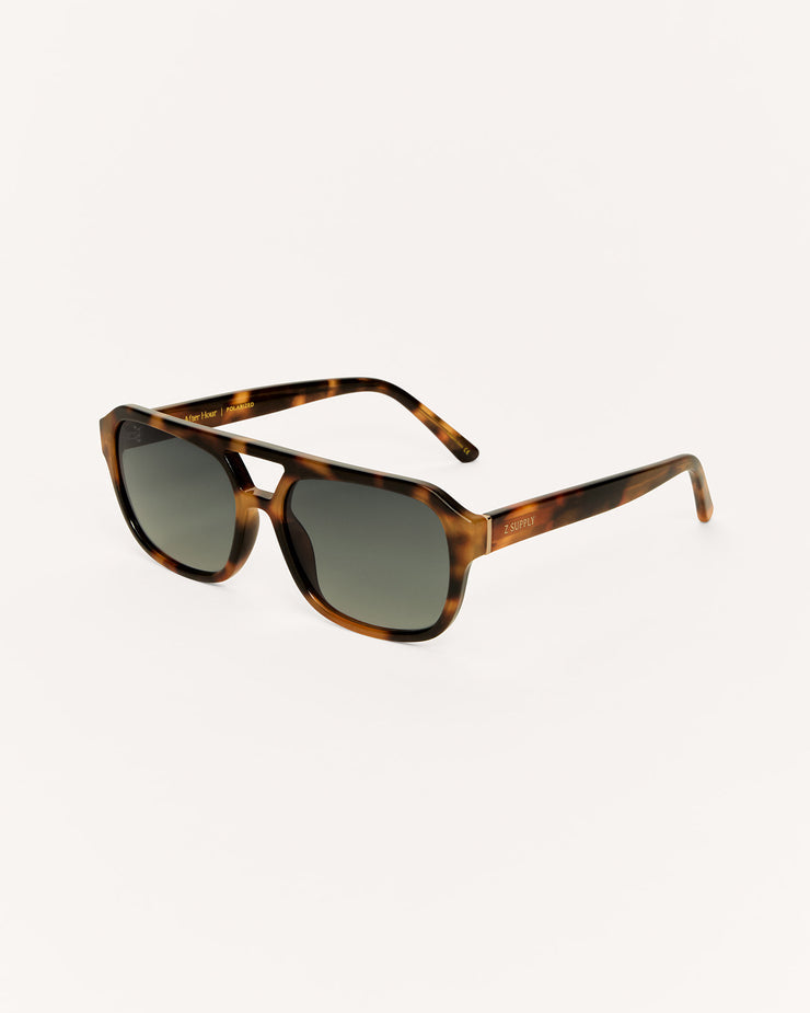Sunglasses with tortoiseshell frame and dark lenses on a white background
