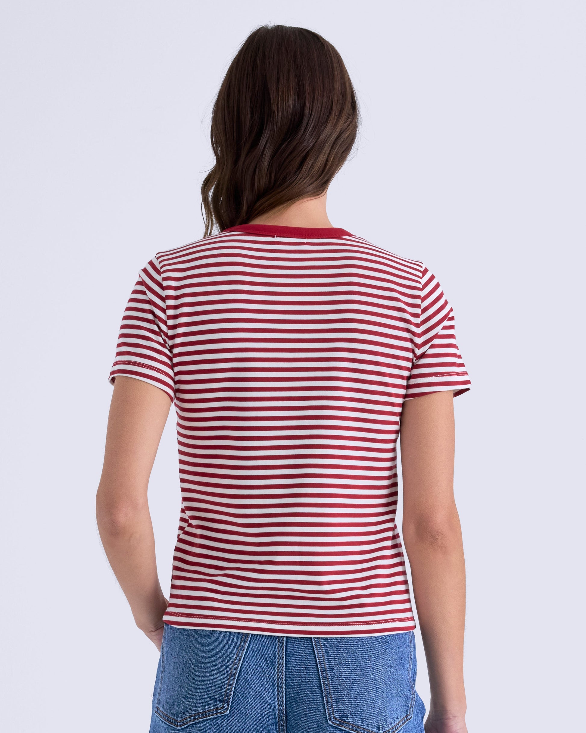 Person wearing a red and white striped shirt and blue jeans on a white background